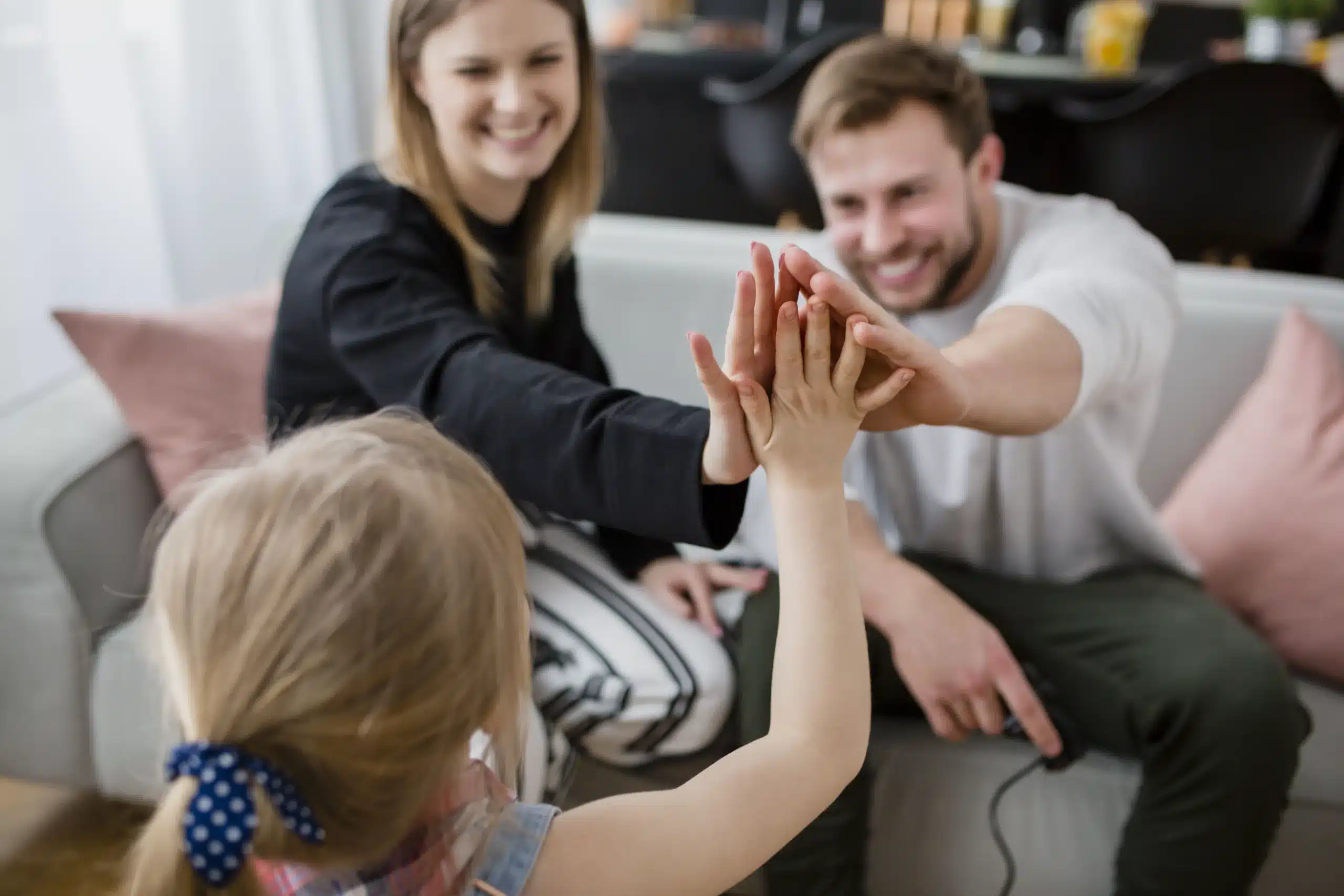 daughter high fiving with parents scaled
