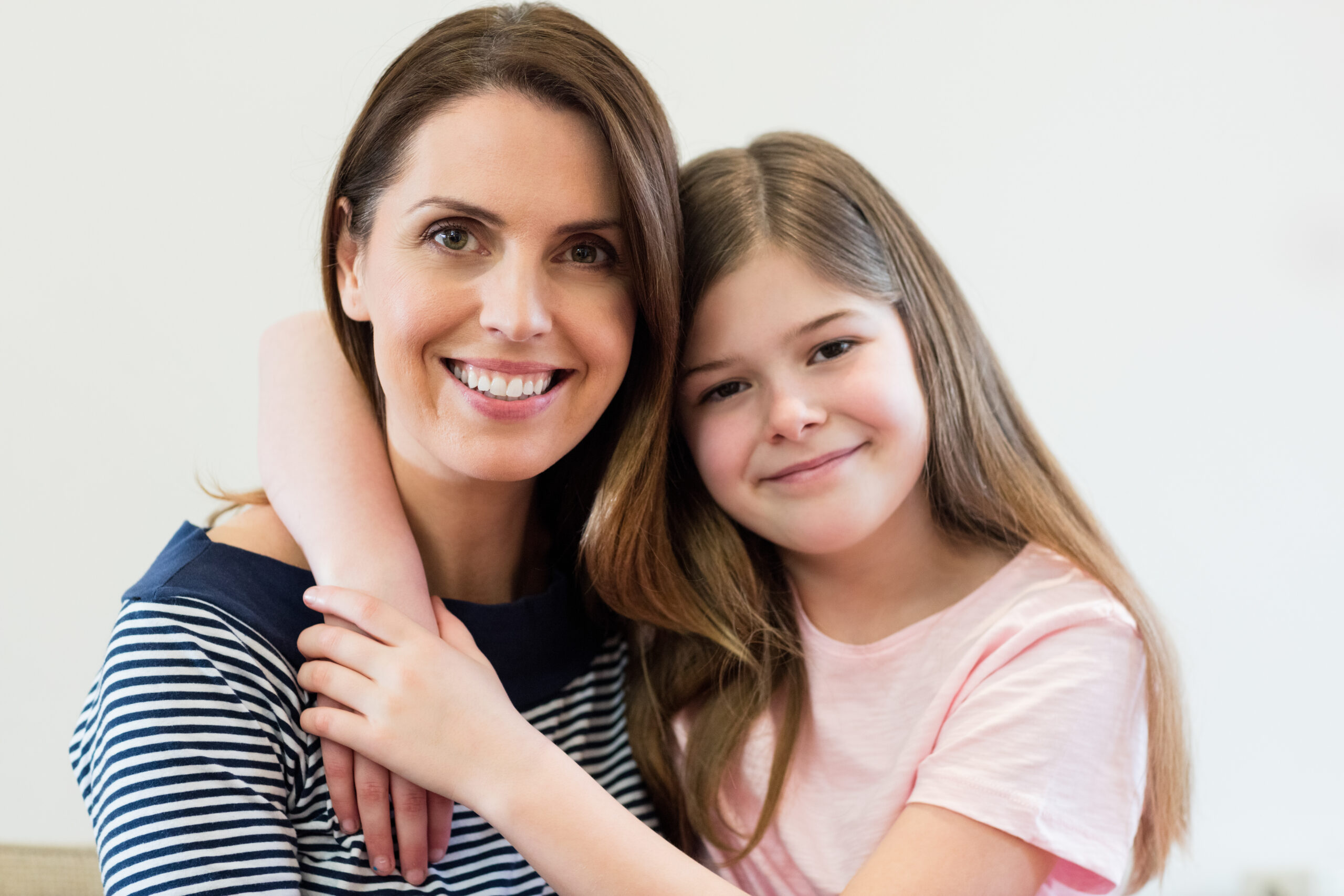 portrait mother daughter embracing each other living r scaled